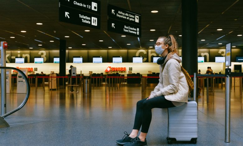 woman sitting on luggage