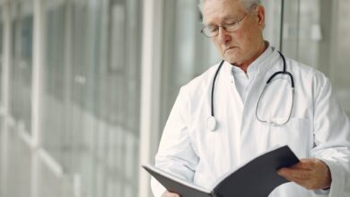 contemplative doctor in uniform reading clinical records