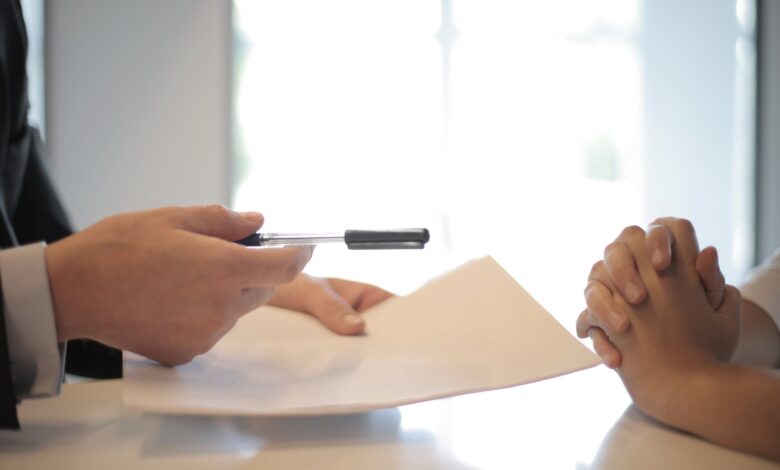 crop businessman giving contract to woman to sign