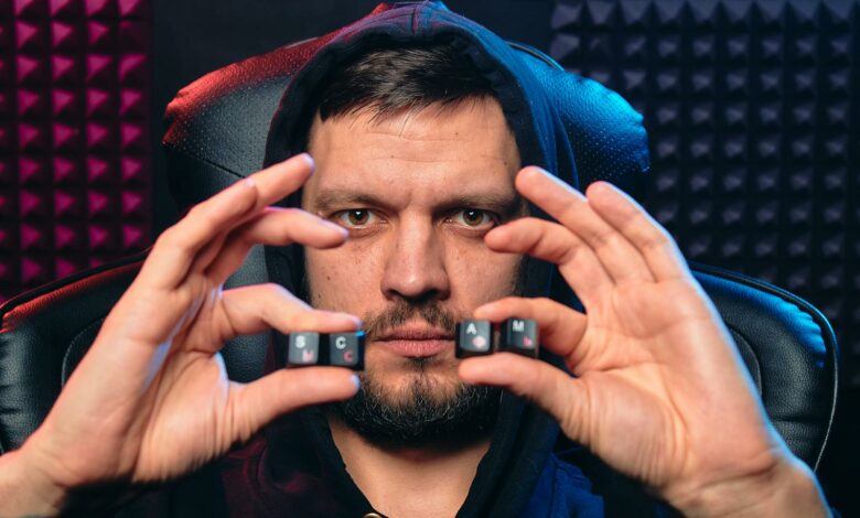 A Man Holding Alphabet Keys of Computer Keyboard