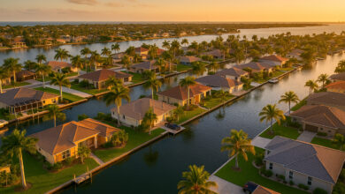 Vue aérienne d’un quartier résidentiel typique en Floride avec maisons, piscines et palmiers, illustrant un investissement immobilier rentable