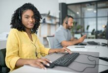 Two professionals working at a call center in Portugal, providing customer service through headsets.