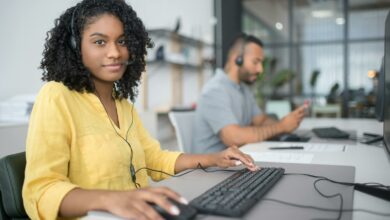 Two professionals working at a call center in Portugal, providing customer service through headsets.